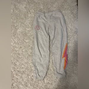 Size small starfit sweatpants with a pink and orange lightning bolt on the side